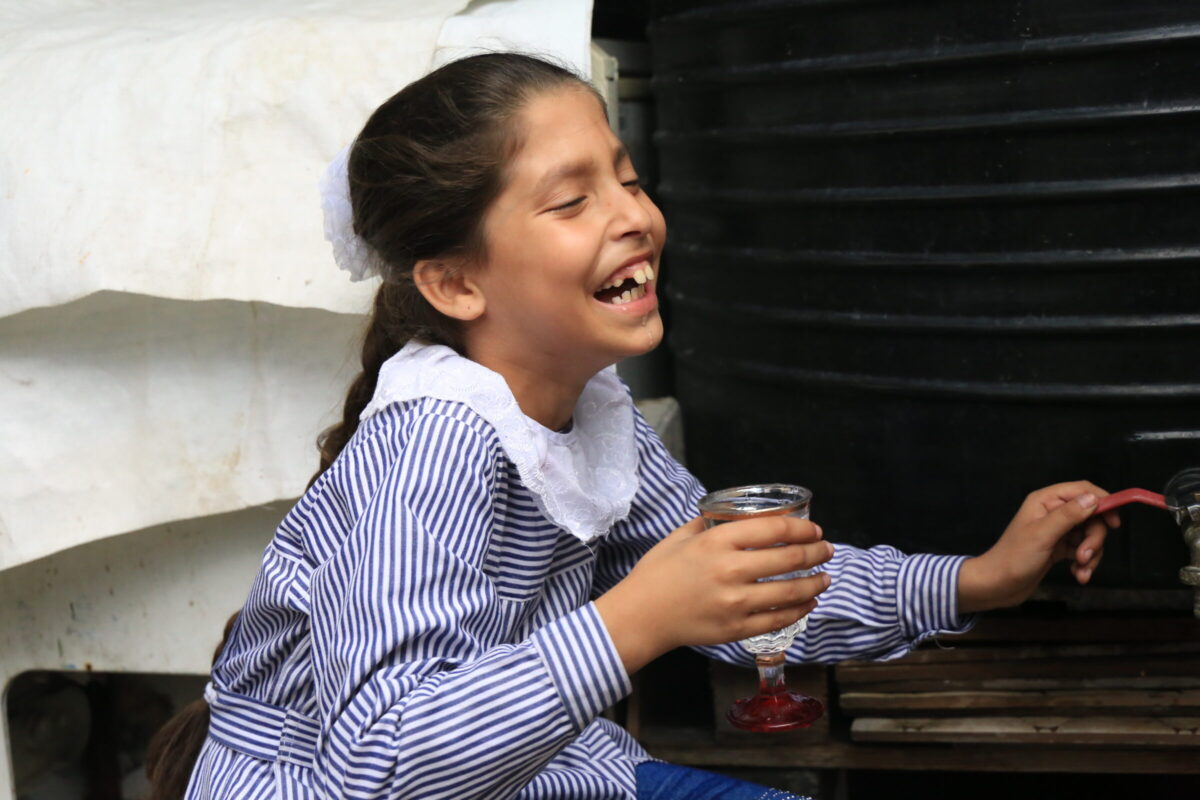 Palestinian girl dirnking water provided by Interpal