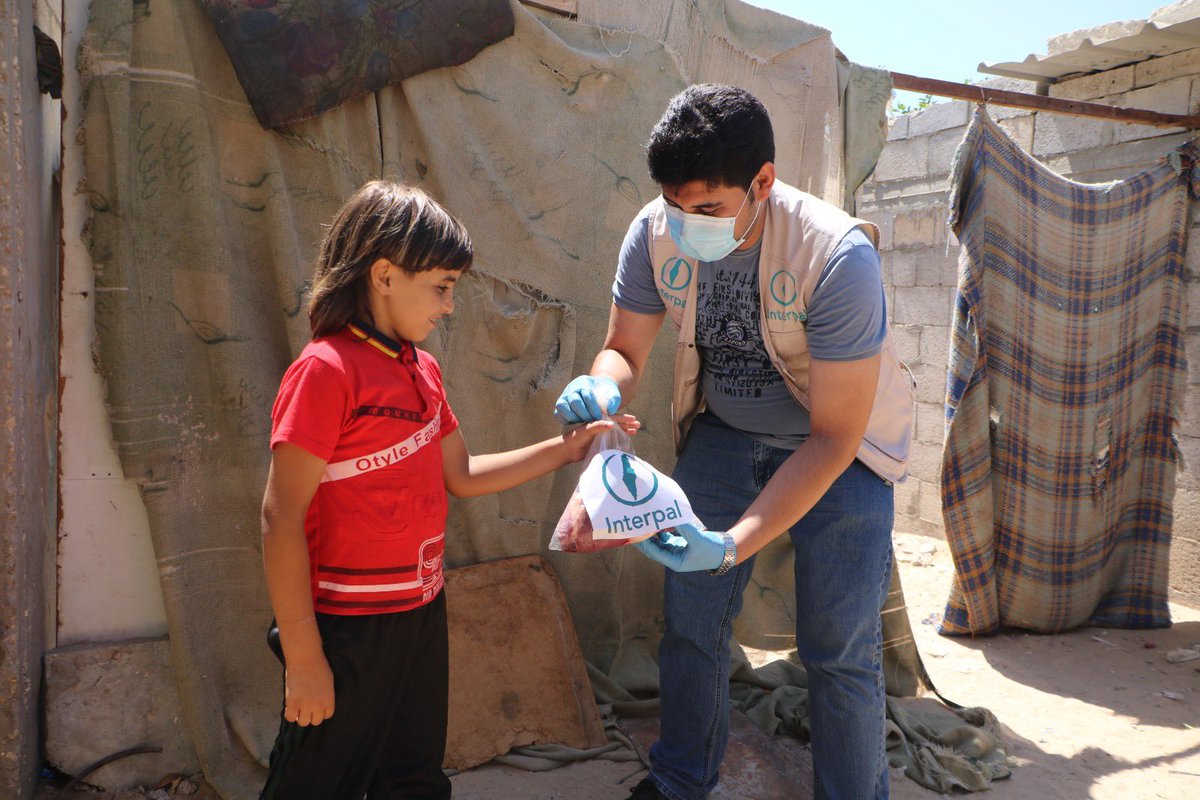 Interpal employee handing out Qurbani meat in Palestine